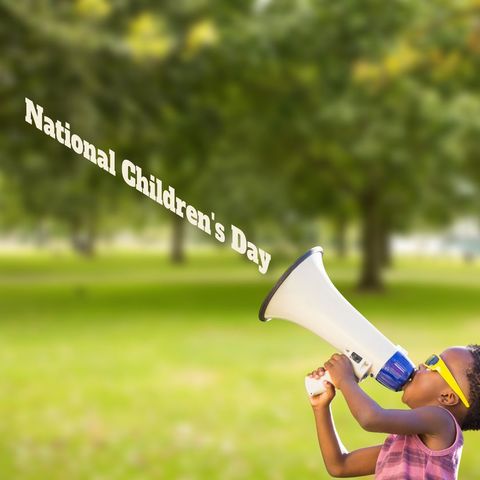 Excited young boy celebrating national children's day outdoors