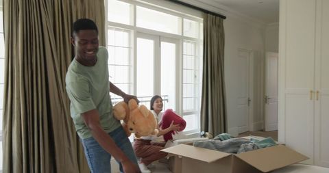 Couple unpacking boxes in new home and embracing happiness