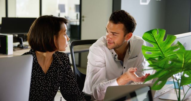 Two Colleagues Engaging in Discussion in Modern Office Environment - Download Free Stock Images Pikwizard.com