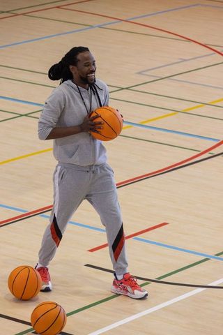 Athletic Middle-Aged Man Holding Basketball on Sport Court