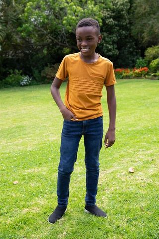 Child Enjoying Outdoor Playfulness on Vibrant Green Lawn
