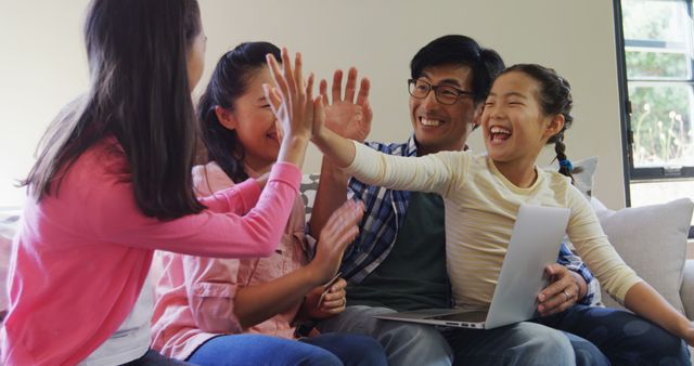 Happy Family Celebrating Together with High Fives on Living Room Couch - Download Free Stock Images Pikwizard.com