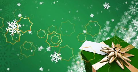 Golden star gift box surrounded by white snowflakes on green background