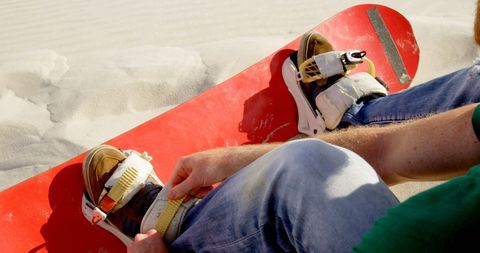 Preparing for exciting snowboarding on sunny day