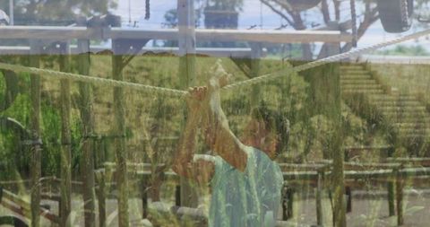 Man climbing rope at outdoor adventure course
