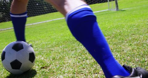 Dynamic soccer action with player engaging ball on lush green field