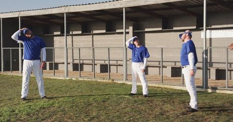 Baseball Team Standing Near Dugout in Athletic Pose