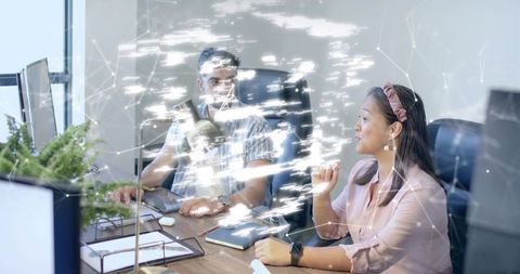 Colleagues Collaborating with Futuristic Digital Interface in Office