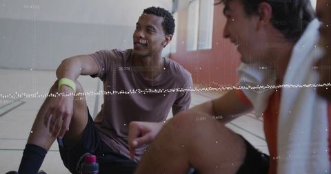 Athletes Analyzing Performance Through Sports Technology in Gymnasium