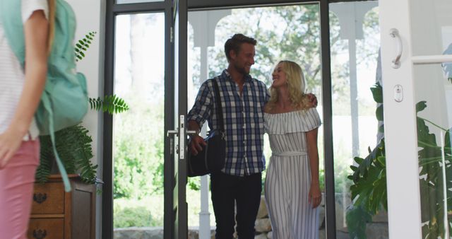 Young Couple Entering Home Smiling with Daughter Leaving - Download Free Stock Images Pikwizard.com