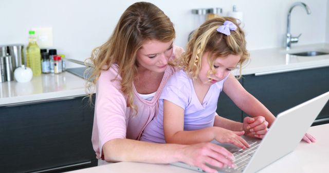 Mother and Daughter Using Laptop at Modern Kitchen Counter - Download Free Stock Images Pikwizard.com