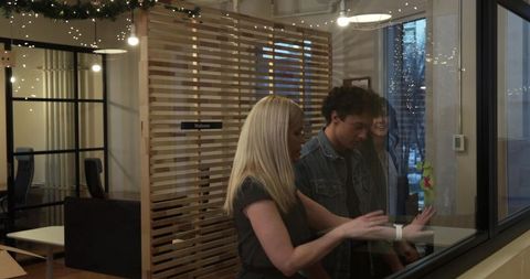 Colleagues moving into modern office with glass wall