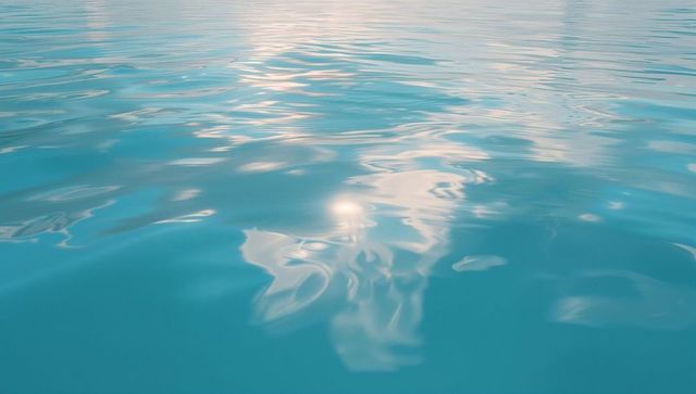 Serene turquoise water reflecting sunlight with minimalist aesthetic