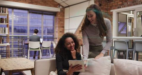 Diverse Women Collaborating in Modern Office Lounge