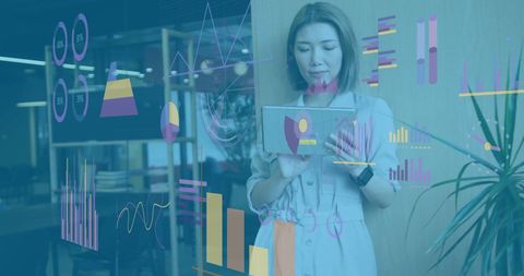 Businesswoman analyzing statistics on tablet with holographic data