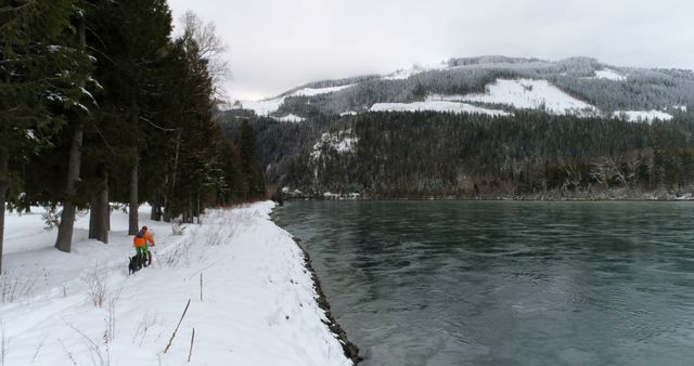 Snowy Mountain Biking Along Frozen Lake in Winter Landscape - Download Free Stock Images Pikwizard.com