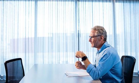 Senior business professional at conference table in modern office