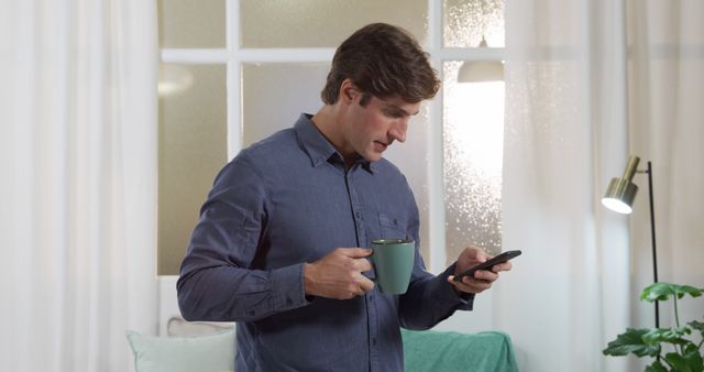 Man Drinking Coffee While Using Smartphone at Home - Download Free Stock Images Pikwizard.com