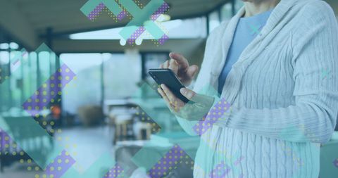 Caucasian Woman Using Smartphone in Modern Office