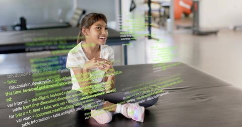Smiling girl coding on laptop in gym wearing striped tee and colorful sneakers with code overlay