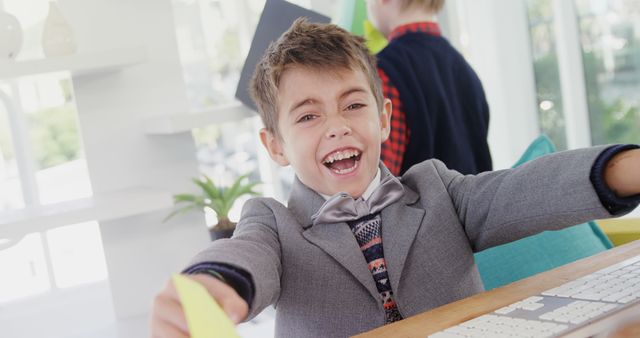 Excited Young Boy in Business Suit Playing in Office - Download Free Stock Images Pikwizard.com