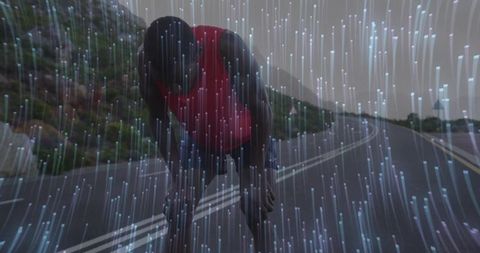 Exhausted runner catching breath on mountain road at dusk