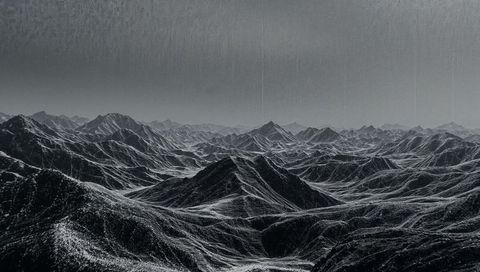 Monochrome wilderness: dramatic jagged mountain landscape with drizzle