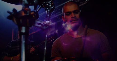 Male drummer immersed in dynamic live performance