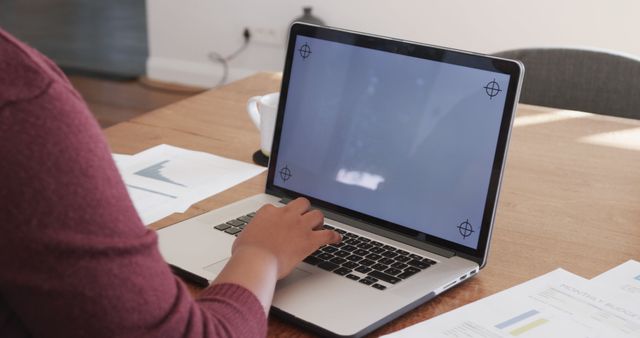 Person Using Laptop at Desk with Documents - Download Free Stock Images Pikwizard.com