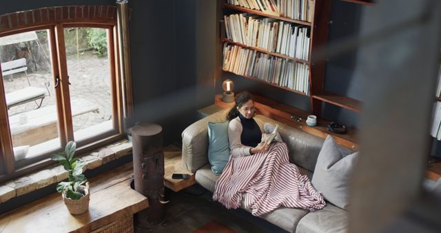 Cozy Morning Indoors with Relaxing Person Reading Book by Window - Download Free Stock Images Pikwizard.com