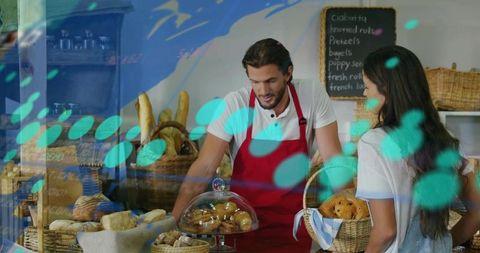 Baker Serving Customer at Rustic Bakery Counter with Fresh Bread Display and Baskets