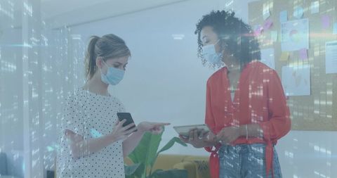 Businesswomen Collaborating with Digital Data Overlay in Office