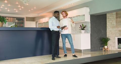 Real Estate Agent Conducting House Tour with Couple in Modern Apartment