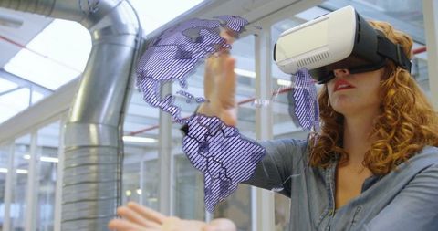 Woman wearing vr headset manipulating holographic world map in modern lab workspace for research