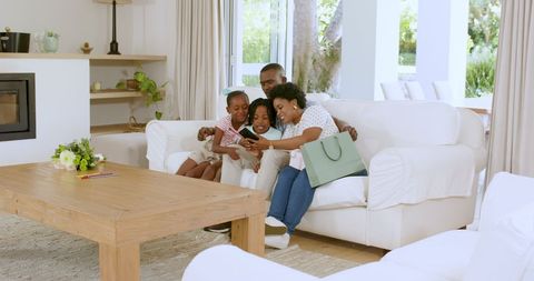 Happy Family Taking Selfie on Couch in Living Room