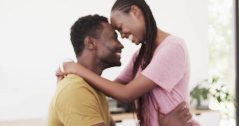 Happy couple embracing at home with love and affection