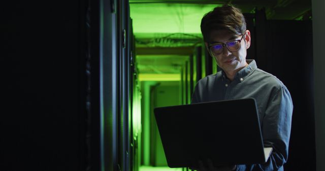 Technician Working in Server Room with Laptop - Download Free Stock Photos Pikwizard.com