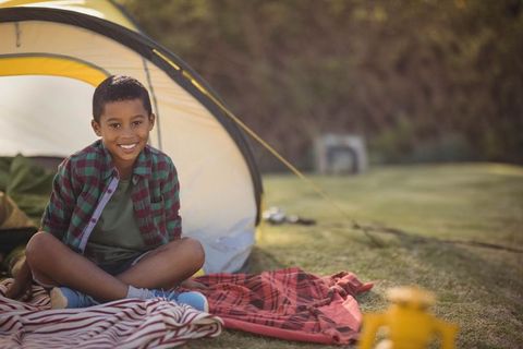 Smiling Young Boy Enjoying Camping Adventure Outdoors