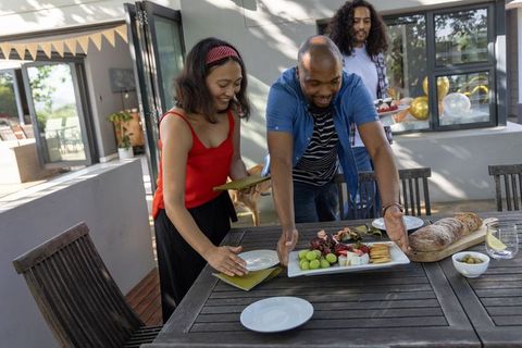 Diverse friends enjoy outdoor dining with appetizers