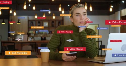 Distracted woman in cafe surrounded by digital notifications, laptop and smartphone alerts