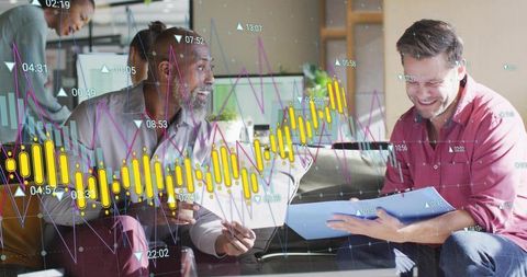 Diverse team collaborating and reviewing analytics overlays on laptop and documents