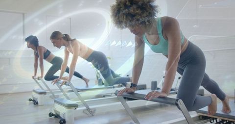 Women Focused on Reformer Pilates Workout in Studio