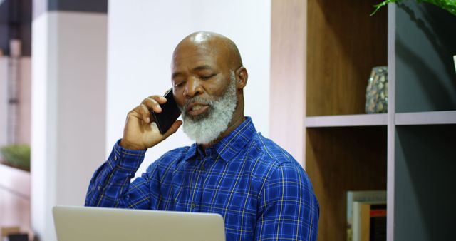 Senior man working and talking on phone in home office - Download Free Stock Images Pikwizard.com