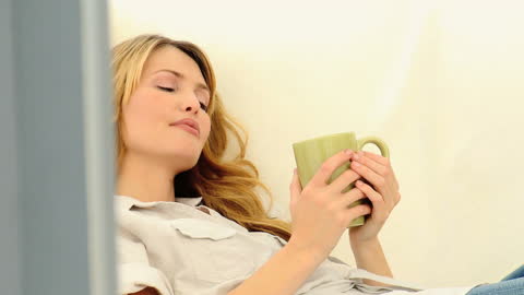 Relaxed Woman Enjoying Coffee Break on Couch