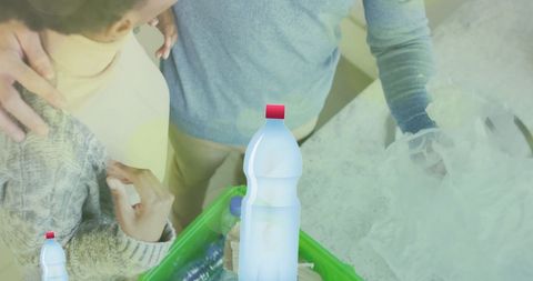 Diverse Couple Recycling Plastic at Home Highlighting Ecology Concepts