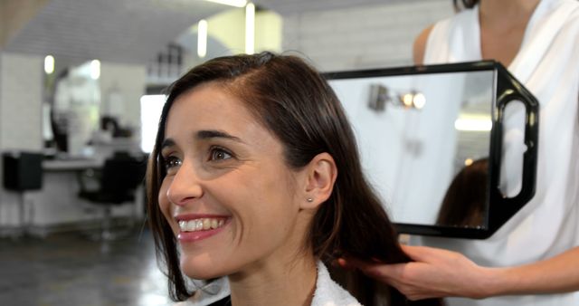 Smiling Woman Admiring Fresh Haircut in Modern Salon - Download Free Stock Images Pikwizard.com