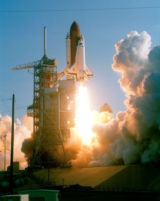 Iconic image of Space Shuttle Discovery launching for first time from Kennedy Space Center. Perfect for educational materials about space exploration, NASA achievements, and technological advancements. Ideal for articles, books, and exhibits focused on space missions and history.