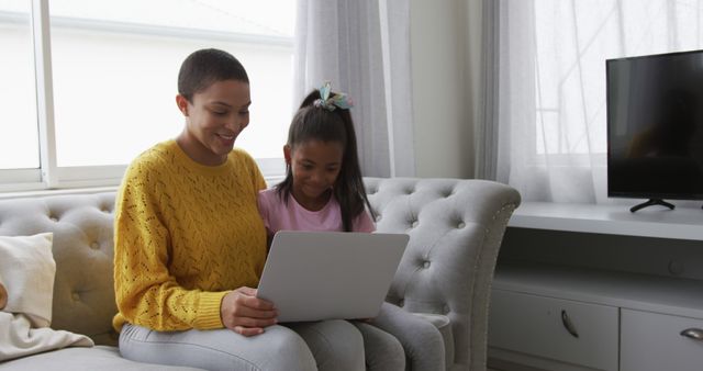 Mother and Daughter Using Laptop on Cozy Sofa in Living Room - Download Free Stock Images Pikwizard.com