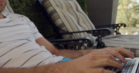 Man Relaxing on Hotel Terrace Using Laptop in Summer