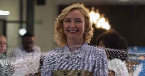 Smiling Businesswoman Overseeing Analytics Team in Modern Office